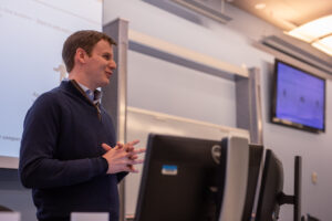 Davis Morrison (MBA '23) teaches an MBA class in the Capital Markets Lab. 